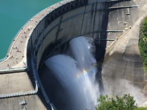 An aerial view of water flowing through a dam.